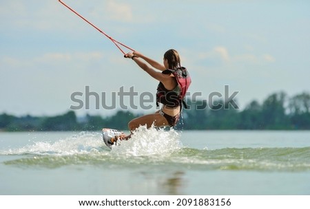 Wakeboarder surfing across a lake Stock fotó © 