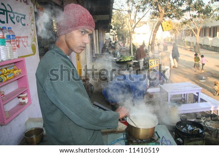 A roadside tea shop owner preparing early morning tea in Rajasthan State of India