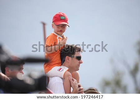 RIO DE JANEIRO, BRAZIL -  May 08, 2014: Father and son supporting the Netherlands national soccer team at their training session for the 2014 World Cup soccer tournament. No Use In Brazil.