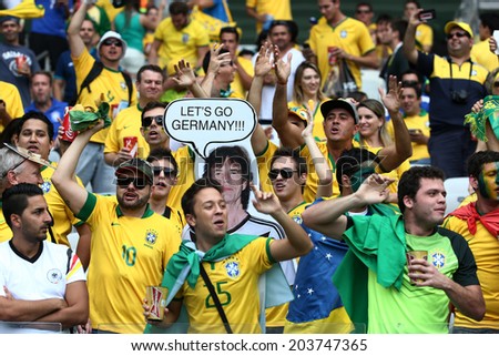BELO HORIZONTE, BRAZIL - July 8, 2014: Brazil soccer fans celebrating at the 2014 World Cup Semi-finals game between Brazil and Germany at Mineirao Stadium. NO USE IN BRAZIL