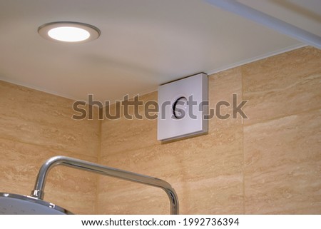 Electric extractor hood in the bathroom. Electric exhaust fan. Ventilation of the air in the bathroom. Maintaining the microclimate in the bathroom. ストックフォト © 