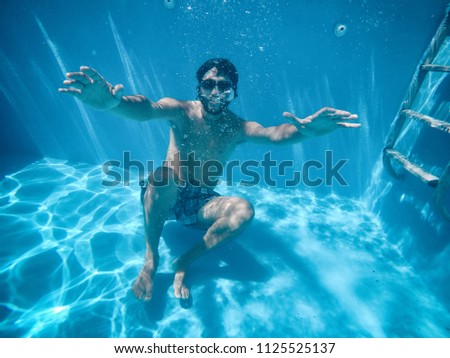 Similar – Image, Stock Photo Man swimming under water in sea