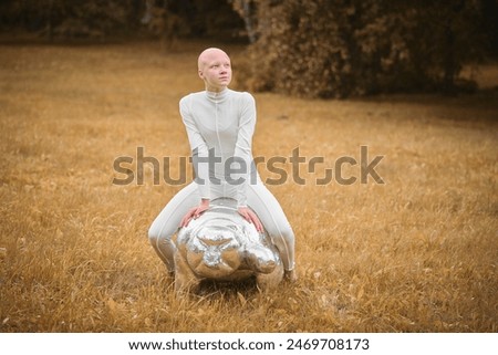 Similar – Image, Stock Photo teenager with wig sitting on a sofa next to a fish