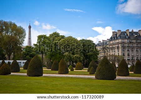 Spring in Paris. Street with a view to Eiffel Tower with dramatic sky. France