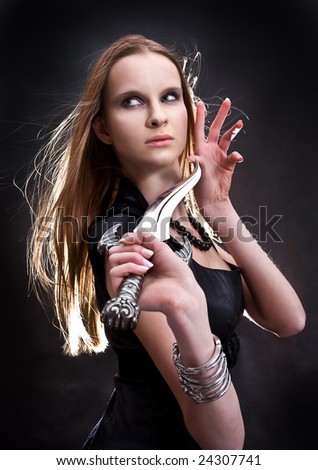 blond young girl holding old dagger