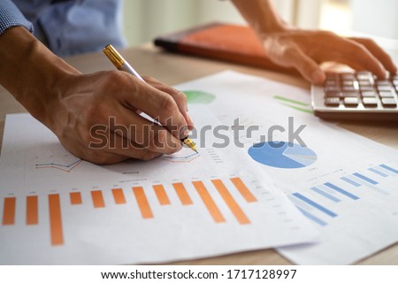 Business men looking at charts, spreadsheets, graph financial development, bank accounts, statistics, economy, data analysis, investment analysis, stock exchange