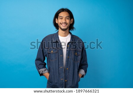 Similar – Image, Stock Photo Long haired young handsome man on a black background with a light illuminating his face, with a flirtatious expression for the camera showing a slight smile