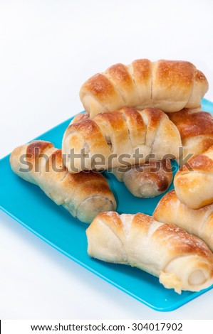 A bunch of sweet rolls on the blue plastic plate.