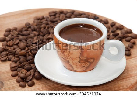 A cup of coffee with raw coffee beans.