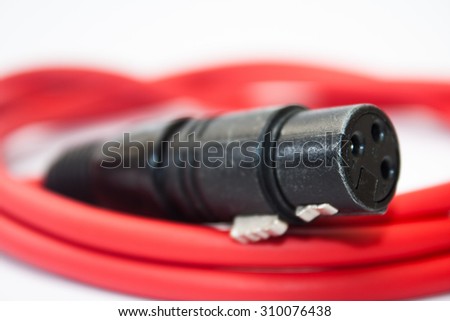 Red xlr microphone cable on the white background.