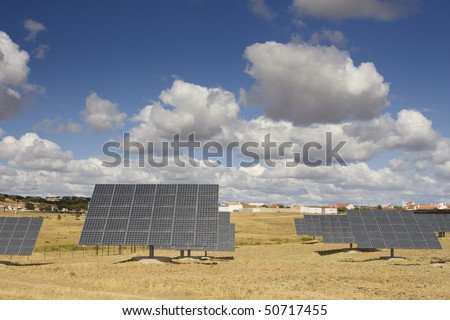Solar panels aligned and faced to the sunlight at a ecology park (Blue and alternative energy)