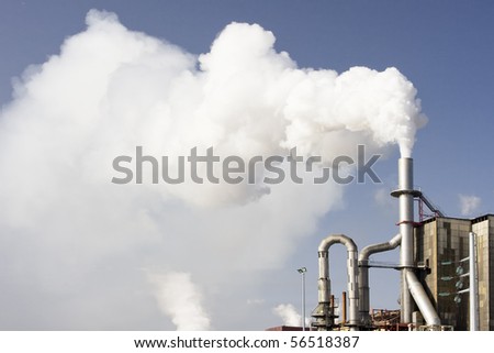 Scary image of white smoke coming out of industrial chimney (ecology problems)