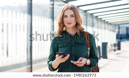 Similar – Foto Bild Frau am Flughafen, die auf die Fluginformationstafel schaut.