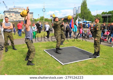 KALININGRAD, RUSSIA - MAY 16, 2015: Soldiers-contract employees carry out power exercises with weights. An action \