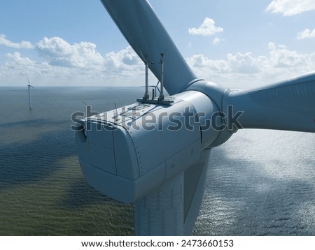 Similar – Image, Stock Photo View of a wind farm in a mountainous forest field with mountains in the background. View during the rising sun. Sunrise