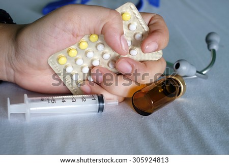 Hand and  birth control pill