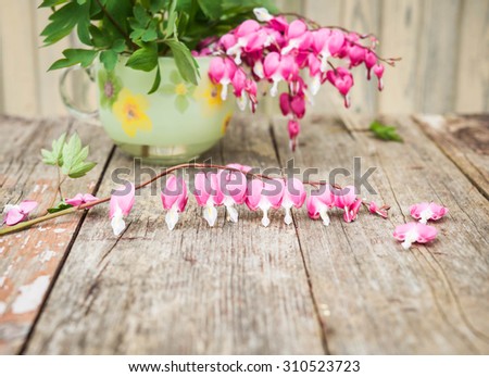 Bouquet of pink flowers. Heart-shaped flowers. Bleeding heart flowers (Dicentra spectabils). Vintage floral background.