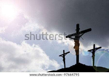 calvary crucifixion with dark sky and rays of light