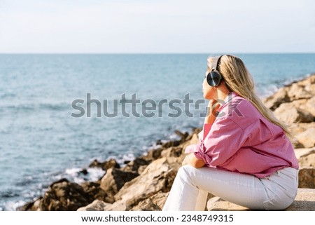 Image, Stock Photo Woman sitting near waving sea