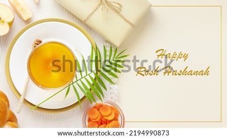 Rosh hashanah, Jewish New Year holiday card. Traditional symbols, apples, honey, carrots, hala and gift on a beige background with congratulations text Happy Rosh Hashanah Stok fotoğraf © 