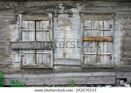 Two windows with shutters closed