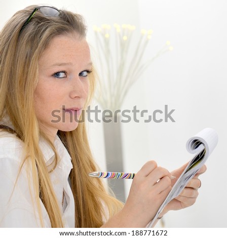 Young woman with pen and paper report