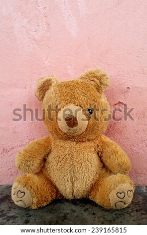 Lonely sad forgotten teddy bear toy with only one eye on the floor. Awaiting for owner
