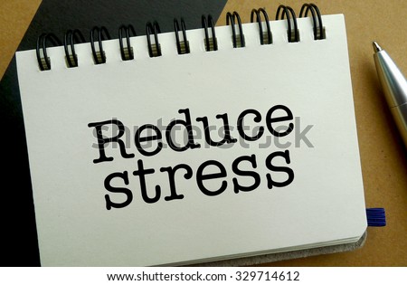 Reduce stress memo written on a notebook with pen