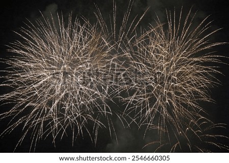 Image, Stock Photo Fireworks explode in two circles with yellow sparks from red smoke