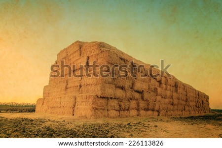 retro picture, autumn or summer landscape with haystack after the harvest of wheat, natural  background with vintage effect