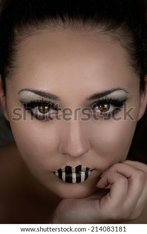 Beautiful young woman with black and white makeup. Closeup. Mysterious fantasy woman. Book cover.