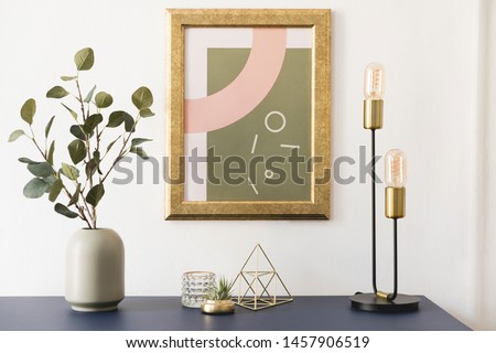 Modern and luxury interior of living room with pomegranate shelf, gold table lamp, mock up poster frame, flowers in vase and elegant accessories. Stylish home decor. Template. White walls. 