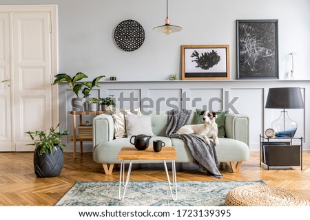 Stylish interior design of living room with modern mint sofa, wooden console, cube, coffee table, lamp, plant, mock up poster frame, pillows, plaid, decoration and elegant accessories in home decor. Foto stock © 