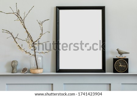 Minimalistic concept on the shelf with black mock up photo frame, dired flower in vase, black clock and elegant personal accessories at stylish home interior. Photo stock © 