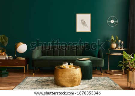Luxury living room in house with modern interior design, green velvet sofa, coffee table, pouf, gold decoration, plant, lamp, carpet, mock up poster frame and elegant accessories. Template.  Foto stock © 