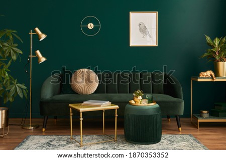Luxury living room in house with modern interior design, green velvet sofa, coffee table, pouf, gold decoration, plant, lamp, carpet, mock up poster frame and elegant accessories. Template. 