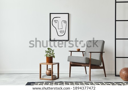 Stylish scandinavian composition of living room with design armchair, black mock up poster frame, plant, wooden stool, book, decoration, loft wall and personal accessories in modern home decor.