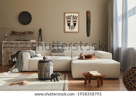 Stylish ethnic living room interior with design modular sofa, wooden stool, moroccan shelf, carpet decor, a lof of decoration and elegant personal accessories. in modern decor. Template.