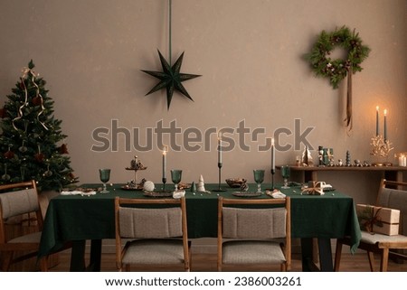 Interior design of christmas dinning room interior with table, christmas tree, chair, wreath, candle with candle stick, gifts, decoration, wooden consol and personal accessories. Family time Template. Imagine de stoc © 