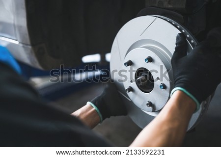 Auto mechanic installing a new six slot brake rotors. Foto d'archivio © 