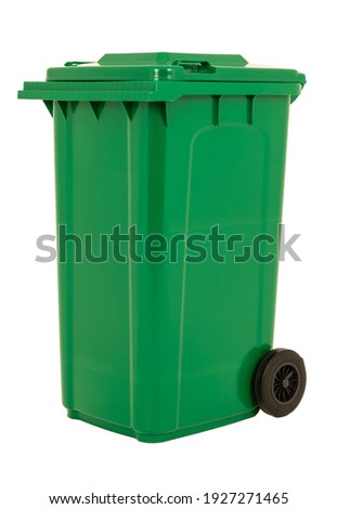 A new unbox green large plastic bin isolated on white background. Wheelie garbage container with a lid. Concept of cleaning, waste separation, and public hygiene. Foto d'archivio © 