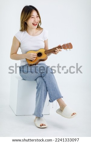 Similar – Image, Stock Photo young woman playing ukulele