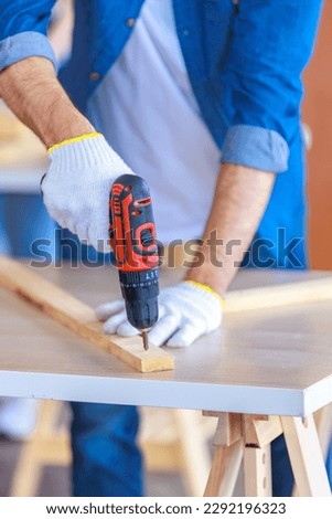 Similar – Image, Stock Photo Unrecognizable handyman using machine on factory