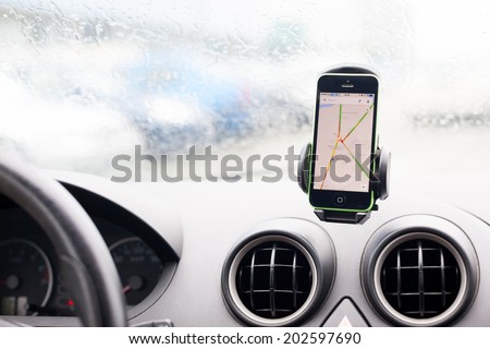 BUCHAREST, ROMANIA - JUNE 27, 2014: Photo of an iphone 5C with google maps in the car