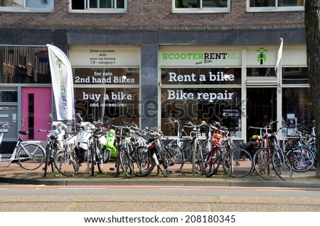 AMSTERDAM, NETHERLANDS - JULY 27, 2014: Sales, rental and repair of bicycles and scooters in Amsterdam, Holland