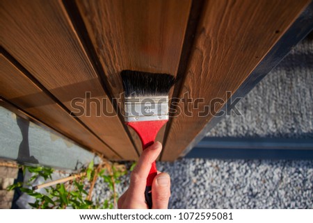 Similar – Image, Stock Photo Glaze. Woodwork, painting wood. Hand of the craftsman painting a wooden door. Concept of renovation work, carpentry and woodwork. painter, painting wooden surface, wood preservation