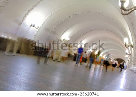 people in motion in underground tunnel, blurred motion