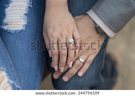 Young married couple holding hands on wedding day