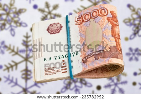 Russian 5000 rubles bank note on the background of snowflakes