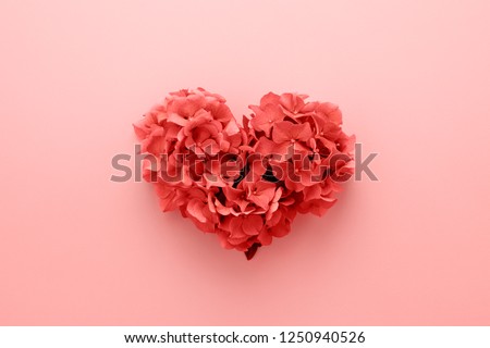 Photo of Living Coral color of the Year 2019. Heart shape made of flowers. Valentine's day. Color palette. Love fashion

